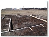 Forms begin on Dan's observatory.  The apparent slope of the ground is not an illusion.  The building site is steeply sloped from north to south.