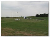 Fence post installation.  For security, the site is fenced with a 6 foot tall security fence.  But it's unobtrusive because of the slope to the south.