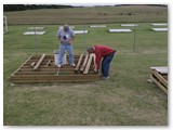 Piers and framing have been started on Mike's buildings but someone has moved into the observatory basement!  David checks out the burrow while Larry cowers at a safe distance.